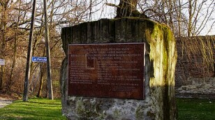 Pomnik upamiętniający ofiary „Sonderaktion Lublin”, bryła pomnika z tablicą z nazwiskami, wieńce pod pomnikiem